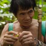 Penan leader Bala Tingang, holding a wild Borneo fruit, <em>bau baku tubu</em>.
